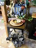 Charming wooden chair, dishes, artificial flowers and arrangements