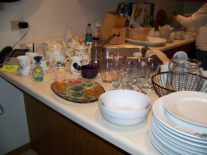 Tea pots, colored glassware and ironstone bowls