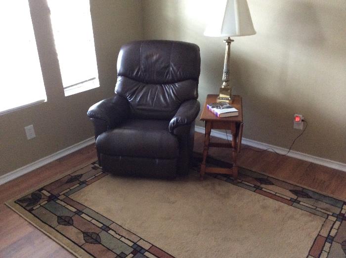 Leather recliner and area carpet. 