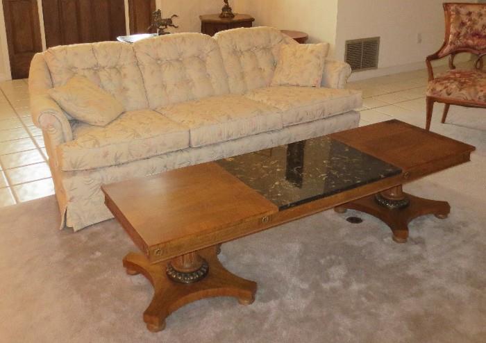 Floral upholstered couch with marble center coffee table