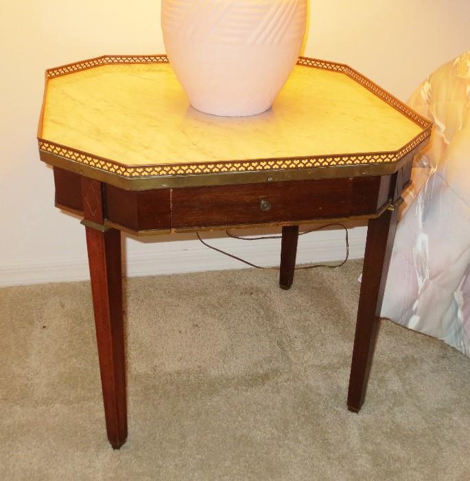Marble top mahogany table with brass top trim and drawer