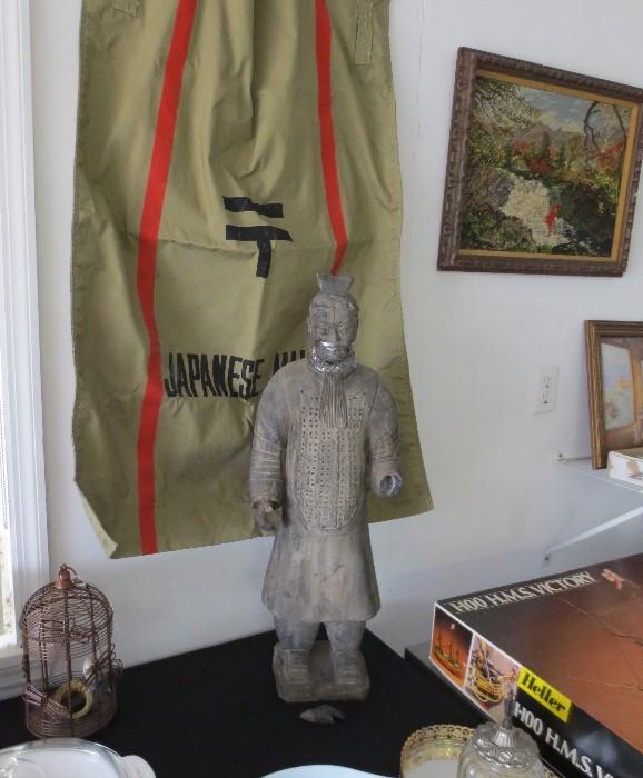 Interesting large Japanese (some type of clay) statue with Japanese mail bag on wall