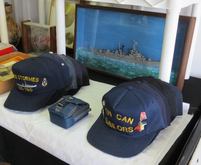 Vintage U.S. Navy veteran ball caps (some with attached pins) and USS John Paul Revell diarama
