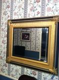 black/gold framed mirror