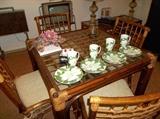 Very comfortable rattan game table with four chairs with padded seats!   Set of four "Magnolia" plates with matching mugs/Irish coffees by Fitz and Floyd.  Another small television (it works!) on wall.