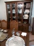 Large, lighted china cabinet with four doors at top and storage below.  Note set of 6 nice caned back dining chairs (inc. 2 arm chairs) and large table with two leaves.