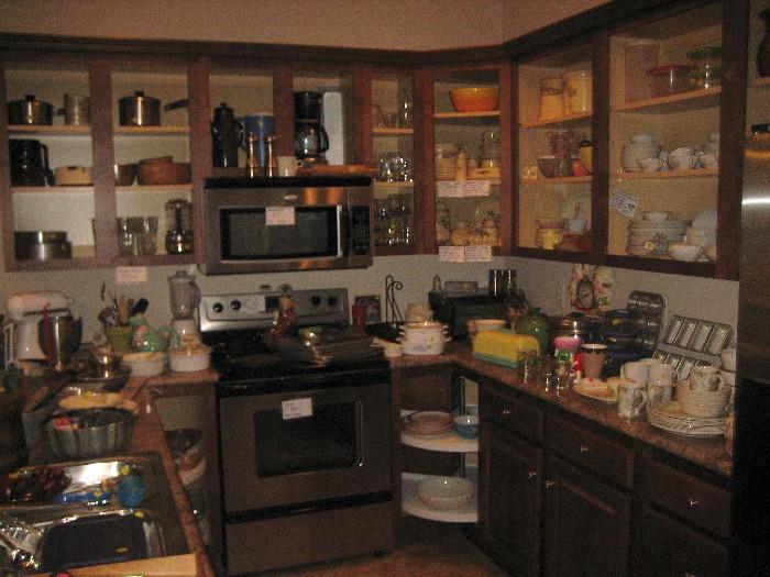 Kitchen packed with china, cookware, and accessories.