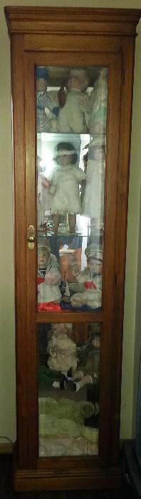 Tall showcase filled with dolls