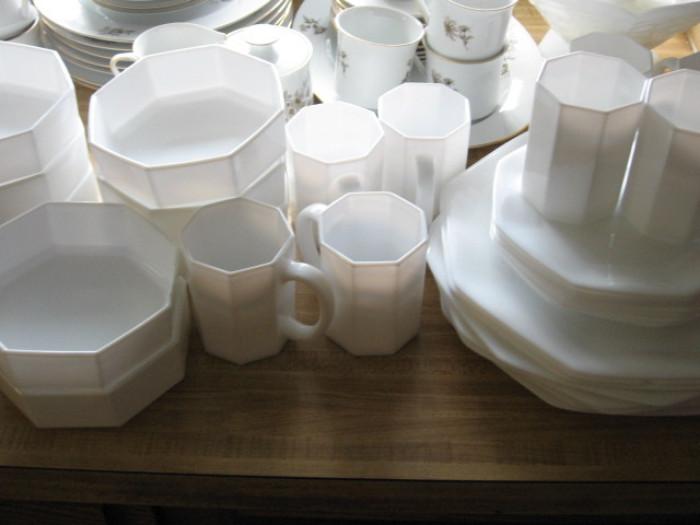 Matching black and white dishes. 8 cups of each color ate salad plates of color eight serial plates of each color eight bowls of each color and eight dinner plates of each color.