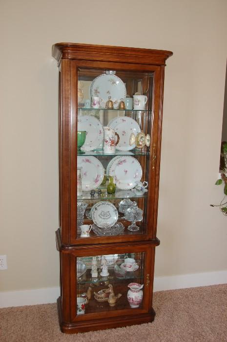 Lighted curio cabinet with antiques