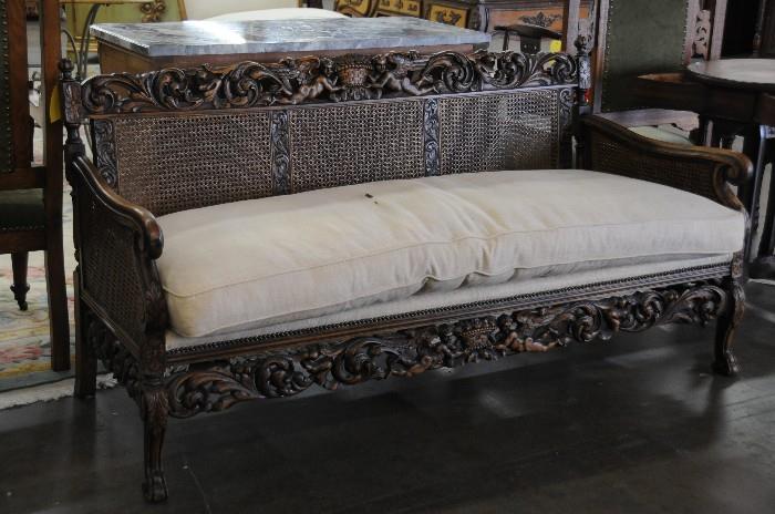 Carved and cane settee