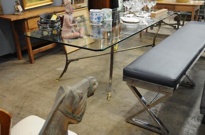 Brass and glass dining table, chrome and leather bench