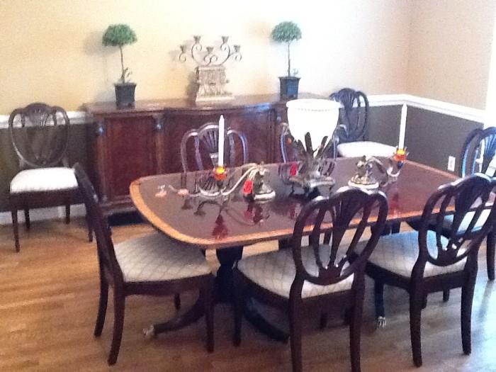 Hickory White Duncan Phyfe Style dining table with 3 leaves, 8 shield back side chairs, mahogany with banding on table edge. Used in model home
