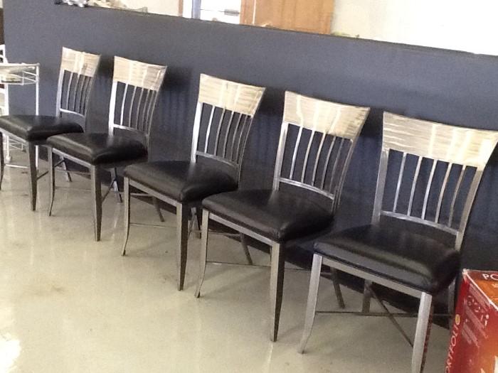 6 Stainless steel chairs with black seats. Have some rust but heavy duty and really good looking. 
