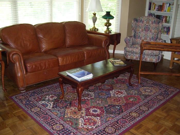 Legacy leather sofa, coffee table, quilt rack, wing armchair and area rug