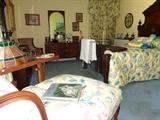 Tiffany hanging lamp, modern nine-drawer dresser and mirror, over-sized chair and ottoman, matching king spread, quilts