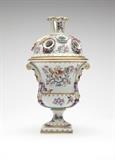 Lot# 1001 A Samson armorial Chinese export style porcelain vase Late 19th century, Paris, with iron red pseudo Chinese seal mark, with a square base and urn-form body flanked by molded foliate scrolls and male masks, with an integral domed cover issuing a flared and pierced neck surrounded by ten circular openings with fluted rims, decorated overall in imitation of Chinese export famille rose porcelain with blossom sprays within cartouche-shaped panels with raised white outlines, and with flowering branches and gilt and iron red spearhead borders, one side centering a faux coat-of-arms, on a white ground, 11.5'' H x 6'' Dia., est: $800/1200