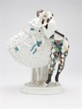 Lot# 1002 A Meissen porcelain figural group of Harlequin and Columbine Circa 1914 - 1915, with underglaze blue crossed swords mark, incised model number ''D.287'' and impressed ''49'', modeled by Paul Scheurich on characters in the Russian ballet ''Le Carnival'', depicting the commedia dell'arte figure standing on point, Columbine wearing a crinoline, her face turned towards Harlequin's, he masked and with one arm around her waist and a baton under the other, on a patterned oval base, 10.75'' H x 8.5'' W x 4.75'' D, est: $3000/5000