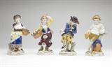 Lot# 1003 Four Chelsea style porcelain figures Late 19th or 20th century, each with spurious painted gold anchor mark, each polychrome-decorated and modeled as a young boy or girl allegorical of one of the four seasons, the first: holding a basket of flowers (7''H); the second: holding a basket of fruit (6.75'' H); the third: holding a sheaf of wheat and leaning against a beehive (6.5''H); the fourth: carrying game, and wearing ice skates (6.5''H); 4 pcs, , est: $500/700