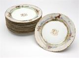 Lot# 1005 Twelve Dresden porcelain plates Circa 1900, overglaze blue mark for decorator Ambrosius Lamm and numbered ''504'', and with underglaze green Rosenthal, Selb ''Versailles / Bavaria'' mark painted over with a gilt rose, each circular, the gilt-edged rims polychrome-decorated with various scenes of woodland fauna in a landscape, each monogrammed in gilt ''KGL'', 12 pcs, each 1'' H x 8.625'' Dia., est: $300/500