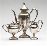 Lot# 1015 A Shreve and Co. sterling silver coffee service Early 20th century, San Francisco, CA, with maker's mark, further marked ''Sterling'', comprising: a coffee pot (10.75'' H x 8.25'' W x 3.75''D), a milk jug with gilt-washed interior (5.5''H x 4''W x 2.5''D), and a covered sugar bowl with gilt-washed interior (5.5''H x 6.5''W x 3.5''D), each hand hammered, each monogrammed to underside of foot ''B'', 3 pcs, gross weight 36 oz troy tw approximately, est: $1000/2000