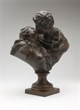Lot# 1020 After Jean Antoine Houdon ''La Baiser Donne'' (The Kiss Bestowed) Late 19th / early 20th century, inscribed ''Houdon'', depicting a young man kissing a maiden, on a circular socle over a square base, patinated bronze, 18.25'' H x 14'' W x 8'' D, est: $1500/2000