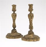 Lot# 1025 A pair of Louis XV style gilt bronze candlesticks Late 19th / early 20th century, one impressed ''GH'', each of baluster form on a circular foot, cast throughout with scrolls and foliage, 2 pcs, 12.25'' H x 6.25'' Dia., est: $1500/2500