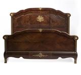 Lot# 1046 A French gilt bronze-mounted parquetry bed Retrofitted from a pair of beds dating from the 19th century, of Regence style, the arched headboard and footboard flanked by fluted uprights, over shaped aprons on short cabriole legs, joined by conforming stretchers, 57.5'' H x 85.25'' W x 95'' D, est: $2500/3500