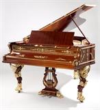 Lot# 1047 A Bechstein French Empire style grand piano
  
1882, serial number 12947, signed ''C. Bechstein / Berlin'', and with paper label to interior, the gilt bronze-mounted case decorated with lyres, scrolling foliage, rosettes and laurel sprays, raised on winged lion monopodia, together with a later associated bench of conforming style, upholstered in blue fabric, 38'' H x 79'' W x 59'' D, est: $50,000/70,000