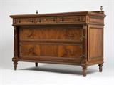 Lot# 1057 A neoclassical style gilt bronze-mounted walnut commode Circa 1920s, marked to locks ''Eagle Lock Co. / Terryville, Conn. / USA'', the book-matched rectangular top over three frieze drawers, above two recessed long drawers flanked by disengaged wrapped columns, on tapering feet, 40'' H x 54.5'' W x 26.25'' D, est: $800/1200