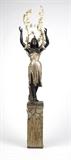 Lot# 1072 An eight-light blackamoor torchiere The female figure of polychrome-painted and ebonized wood, the foliate pedestal base of polychrome-painted wood, the two floriform candle arms of gilt metal, electrified, 90'' H x 10.5'' W x 12'' D, est: $2000/3000
