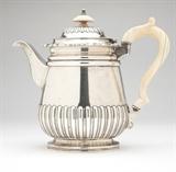 Lot# 1085 A Regency sterling silver teapot
 
1818, Birmingham, maker's mark of Matthew Boulton, the domed, hinged lid gadrooned and topped by a bone finial, the spreading cylindrical body with floral rim and gadrooned to lower half, with a bone handle, 8'' H x 9'' W x 5'' D, gross weight 26.7 oz troy approximately, est: $800/1000