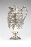 Lot# 1098 A Victorian sterling silver ewer
 
1873, Glasgow, maker's mark ''GE & (?)'' (probably George Edward and Sons), the hinged lid over an ovoid body issuing a scrolled handle and short spout, chased and repousse-decorated all over in Renaissance Revival style with shield-shaped cartouches, flowers, fruit, foliage, and strapwork on a stippled ground, on a conformingly decorated circular foot, 11.25'' H x 7.5'' W x 5'' D, gross weight 32.4 oz troy approximately, est: $1500/2500