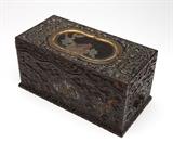 Lot# 1110 A Japanese lacquered, shell-inlaid & carved wood writing box Edo Period (1603 - 1867), with carved signature to underside, rectangular, the cover relief-carved with a profusion of scrolls and foliage, centering a panel within a molded gilt border containing a bird perched on a flowering branch, lifting to reveal a removable utensil tray with a mother-of-pearl-inlaid edge and inset with silver water dropper and ink block, over a similarly carved body, the front, rear and one end panel body each centering figures of various animals, one end panel enclosing a drawer with a cast metal pull, together with various accessories, 5.5'' H x 11.5'' W x 6'' D, est: $500/700