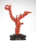 Lot# 1122 A Chinese carved red coral figural group
 
20th century, depicting two female figures, a child and a bird, mounted on a carved wooden stand, overall 12.75'' H x 9.5'' W x 4'' D, est: $2000/4000