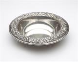 Lot# 1132 An S. Kirk & Son sterling silver bowl1932 - 1979, Baltimore, MD, marked ''S. Kirk & Son / Sterling / 30 F'', circular, the down curved lip repousse-decorated with mixed flowers and foliage, 2.25'' H x 10'' Dia., 13.4 oz troy approximately, est: $600/800
