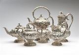Lot# 1133 An S. Kirk & Son sterling silver tea / coffee service
 
Late 19th / early 20th century, with maker's mark, further marked ''925/1000'', comprising: a tipping kettle with burner (13'' H x 9'' W x 7.5'' W), a coffee pot (10.25'' H x 10'' W x 5.5''D), a teapot (7'' H x 10.75'' W x 6'' D), a milk jug (7'' H x 6.5'' W x 4.5''D), a covered sugar bowl (6'' H x 7.5'' W x 5'' D), and a waste bowl (4.5'' H x 5.75'' Dia.), each repousse-decorated with mixed flowers and foliage on a stippled ground, with floriform finials, monogrammed to undersides ''MM'', 6 pcs, gross weight 174.8 oz troy tw approximately, est: $6000/9000