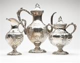 Lot# 1135 An American sterling silver sterling silver part coffee service Late 19th / early 20th century, with retailer's mark ''Loring Andrews & Co.'', further marked ''Sterling'', comprising: a coffee pot (12.5'' H x 10.25'' W x 5.25'' D), a pitcher (8.125'' H x 5'' W x 3.75'' D), and a covered urn-form vessel (8.75'' H x 7.25'' W x 5'' D), the baluster-form bodies with repousse and chased grape clusters and foliage, with faux vine handles and finials, monogrammed ''W'', 3 pcs, gross weight 72.1 oz troy tw approximately, est: $2000/3000