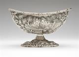 Lot# 1137 An American sterling silver bowl Late 19th / early 20th century, with retailer's mark ''(T)he Loring Andrews / Cincinnati / USA'', further marked ''Sterling'' and ''102A'', the navette-form body with a scalloped foliate rim and repousse-decorated on both sides with a castle in a wooded landscape surrounded by floral scrolls and birds, over a conforming decorated domed foot, 4'' H x 6.5'' W, 8.15 oz troy approximately, est: $600/900
