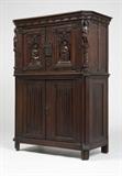 Lot# 1146 A Gothic style carved oak cabinet Early 20th century, the rectangular top with angled corners over a conforming case with a figure of a knight standing on a pillar to the upper part of each front angle, enclosing a pair of hinged doors each centering a seated female figure beneath a tracery arch, over a further pair of doors with linenfold decoration, the side panels also with linenfold decoration, with wrought iron hardware, 53'' H x 38.5'' W x 18.5'' D, est: $1000/2000