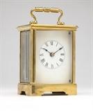 Lot# 1182 A Vermont Clock Co striking carriage clock
 
1898 - 1902, Fairhaven VT, signed to backplate ''Vermont Clock Co. / Fairhaven, VT., USA, the glazed polished brass case enclosing the white dial with black Roman numeral dial with minute track, side-by-side winding harbors, gongs on the hour and the half, with key, 7.25'' H x 4.375'' W x 3.5'' D, est: $500/800