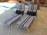 2 metal chaise lounges with striped pads