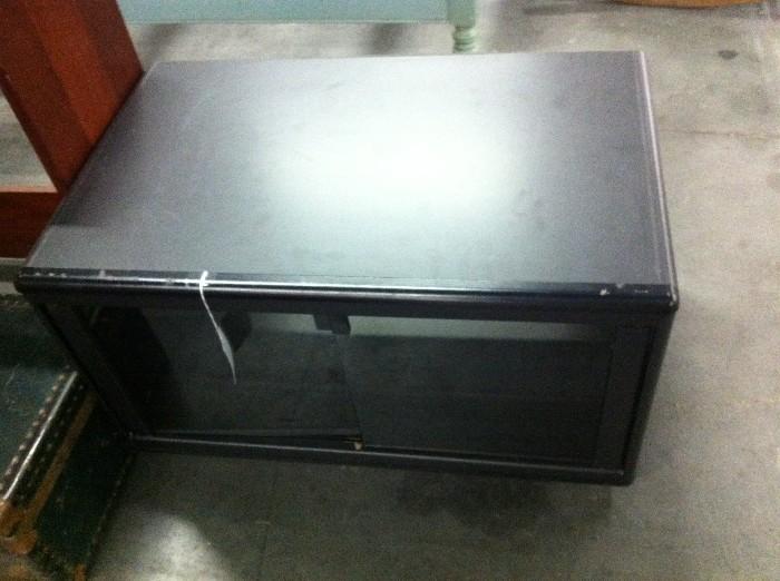 Black/Glass TV Stand. Smaller unit with DVD storage or a spot for your cable box or game center.
