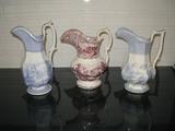 3 beautiful transferware water pitchers, the center one is lavender in color