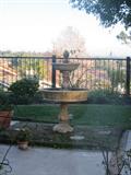 Garden fountain, round Kingsley and Bate Teak table and chairs.