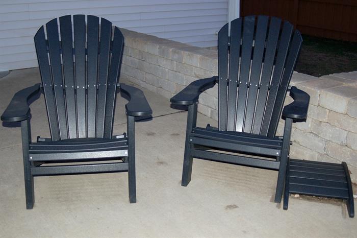 Two black Adirondack chairs and table. 