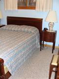 Double bed & nightstand of the bedroom set.