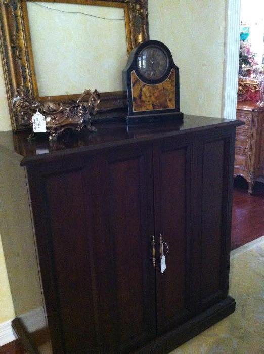                  storage cabinet; mantel clock; frame