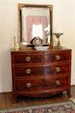 Early 19th century Hepplewhite style bowfront chest with flame mahogany veneers; Milk glass daisy lamp