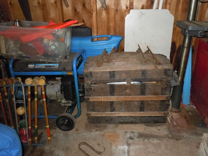 this phot is of the garage area. Shown is a domed top trunk but on the right side you can see the Goodyear outboard motor.  The motor is from the 1920-40's.   Mr Mcwethey ran a Goodyear store in Weedsport and built boats including the racing boat in this sale.  The Goodyear motor is unusual and was used on a canoe by Mr. McWethy, the grandfather.